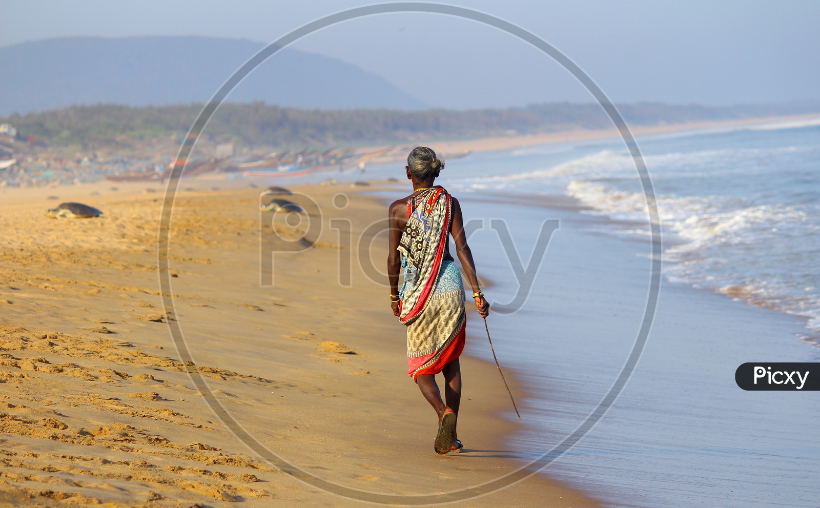 Old Woman walking in Beach