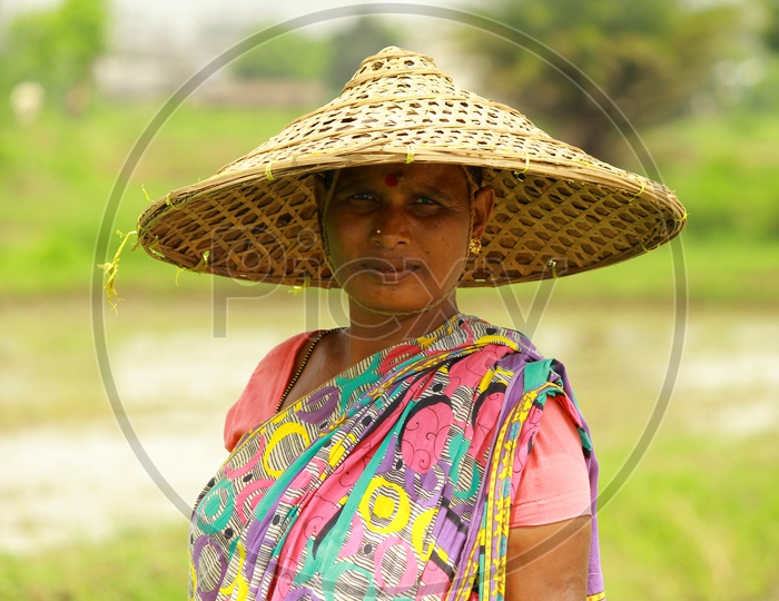 Woman in Paddy Field wearing Traditional Hat