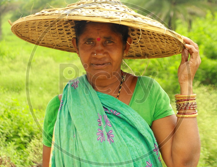 Woman in Paddy Field Wearing Traditional Hat