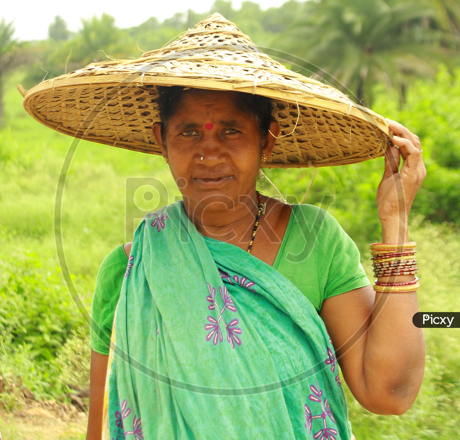 Woman in Paddy Field Wearing Traditional Hat