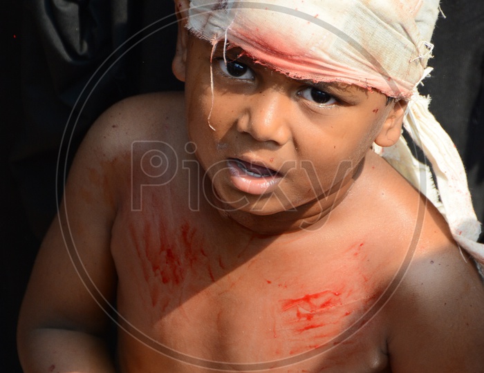 Muslim Child flagellate himself in a procession to mark Ashoura during Muharram