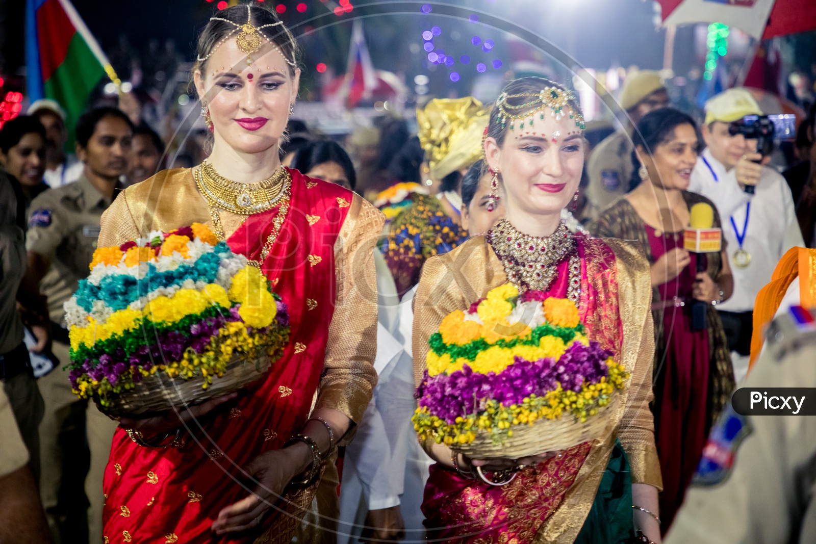 Foreigners clad in traditional attire danced around Bathukammas in Hyderbad