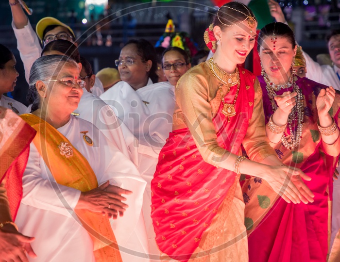 Foreigners clad in traditional attire danced around Bathukammas in Hyderbad
