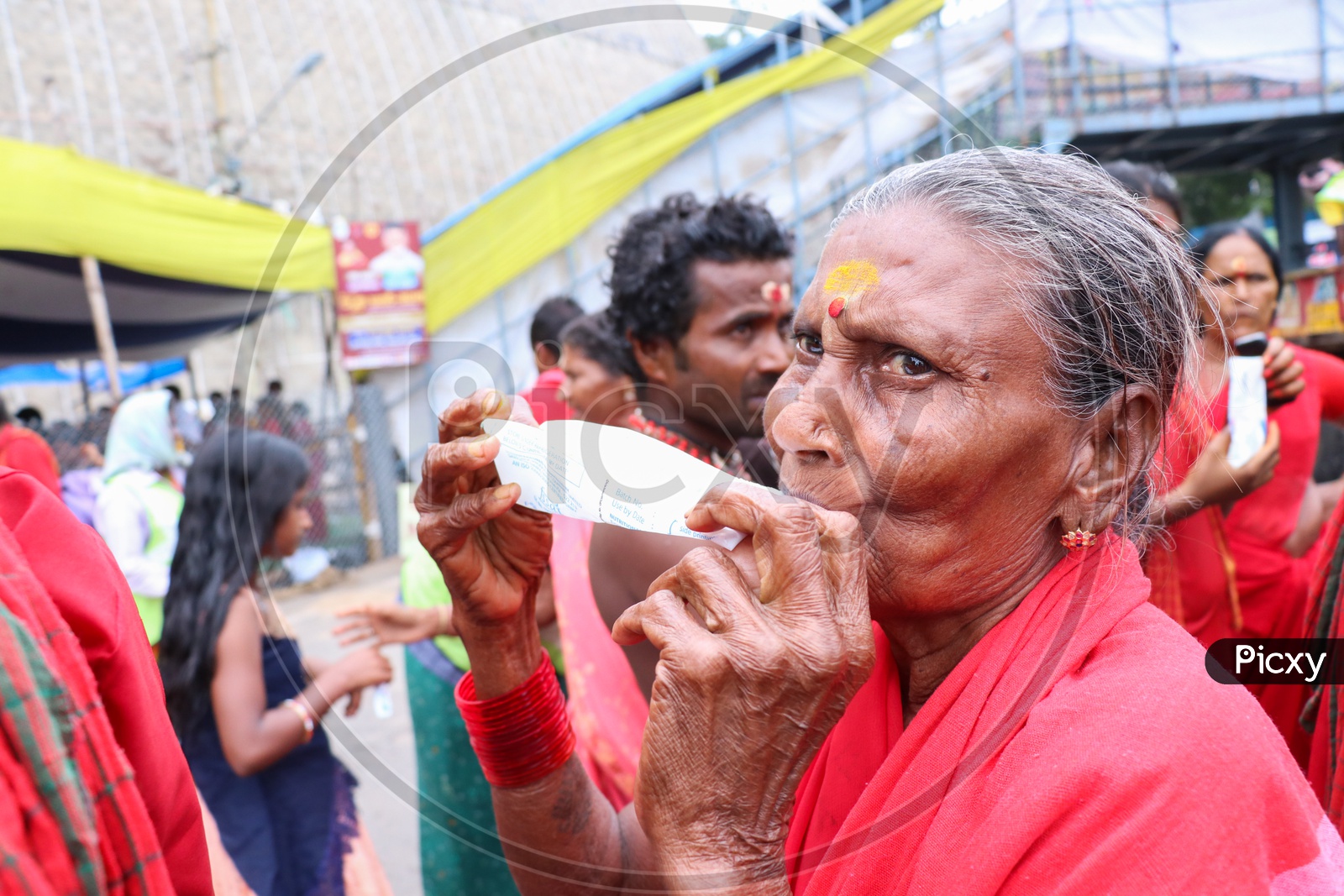 An elder bhavani drinking butter milk offered by AP govt on 9th day of Durga Navrathri