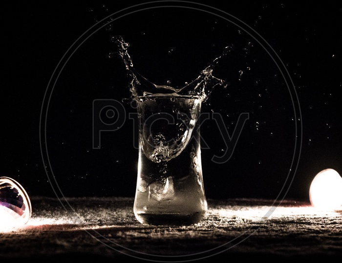 Stone Drop into  Water Glass