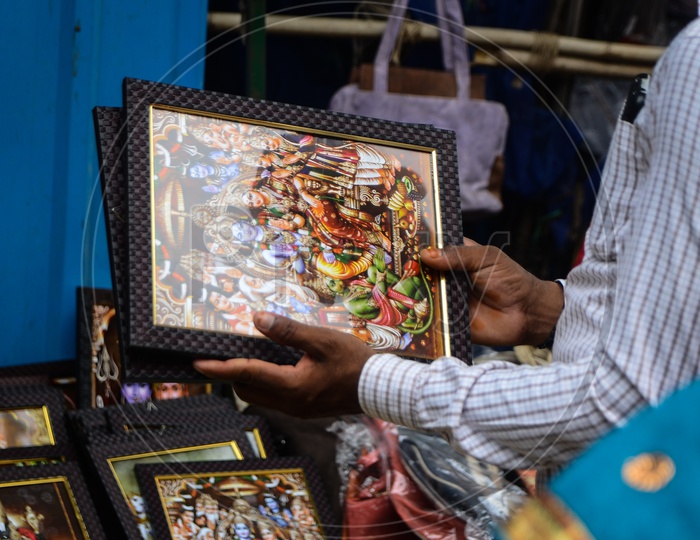 Devotees buy photo frames of  Hindu god