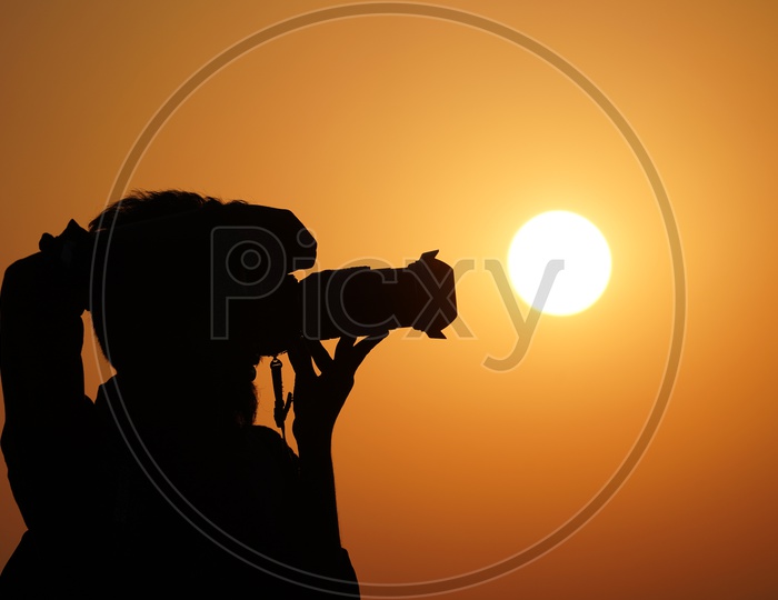 Photographer Capturing Sunset