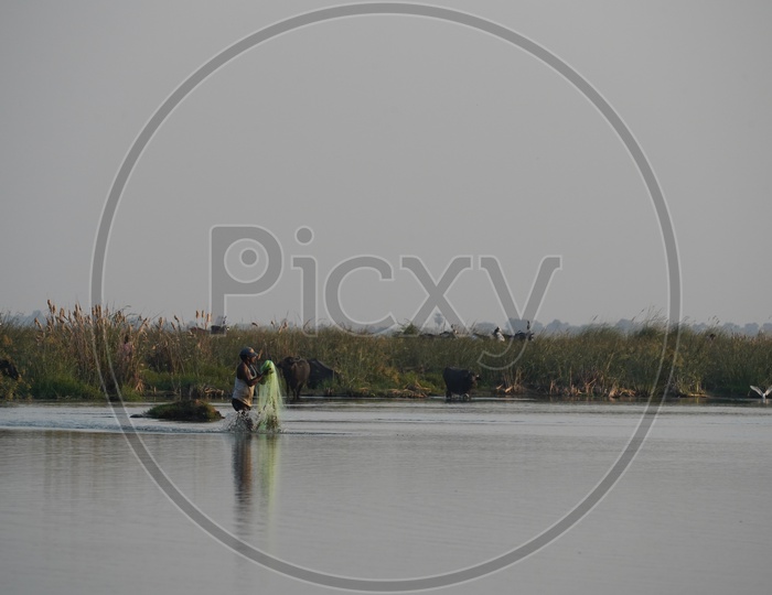 Fisherman throwing Fishing Net