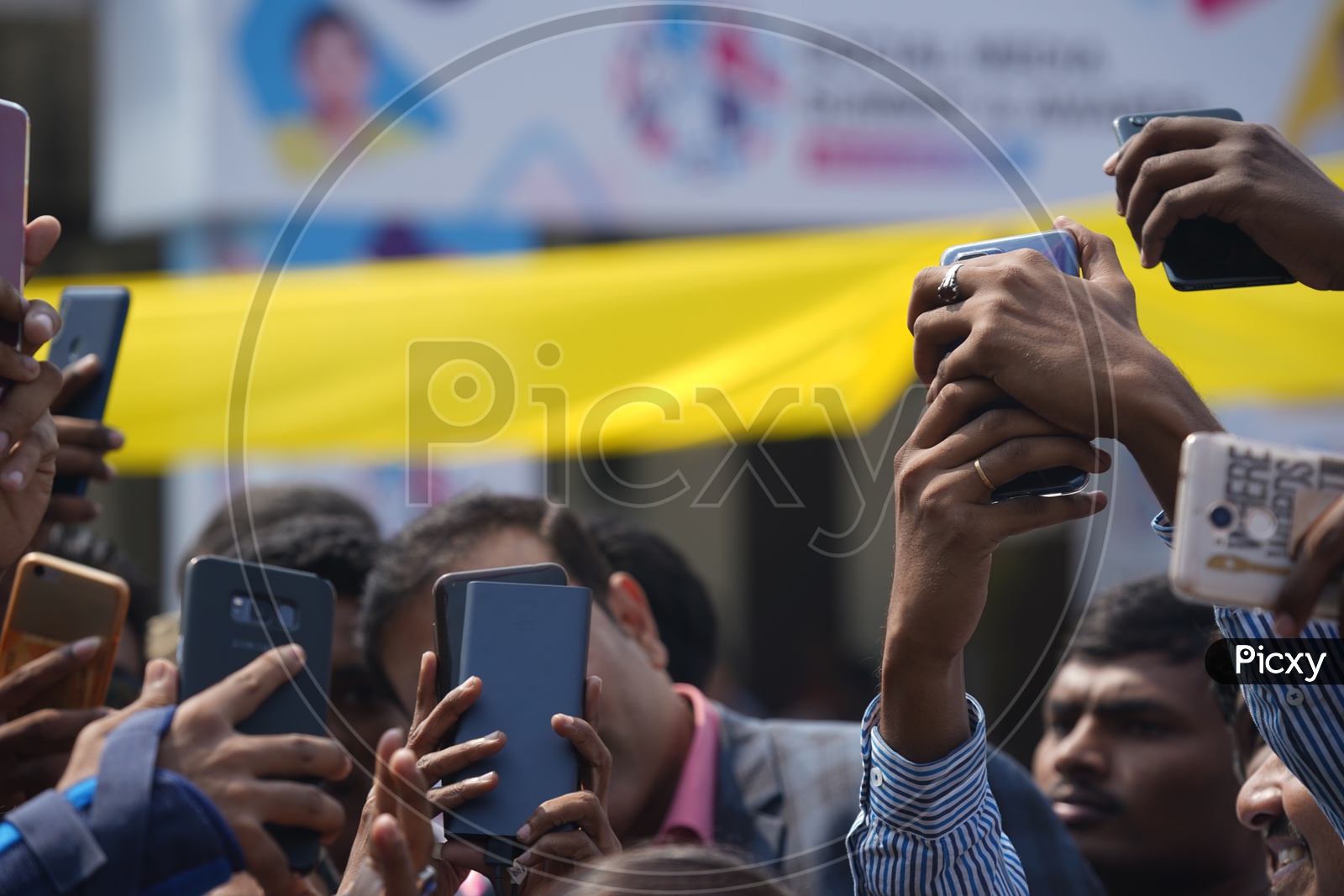 Students take selfies with former Indian cricketer V V S Laxman while he arrives to address the Social Media Summit in Amaravati 2018