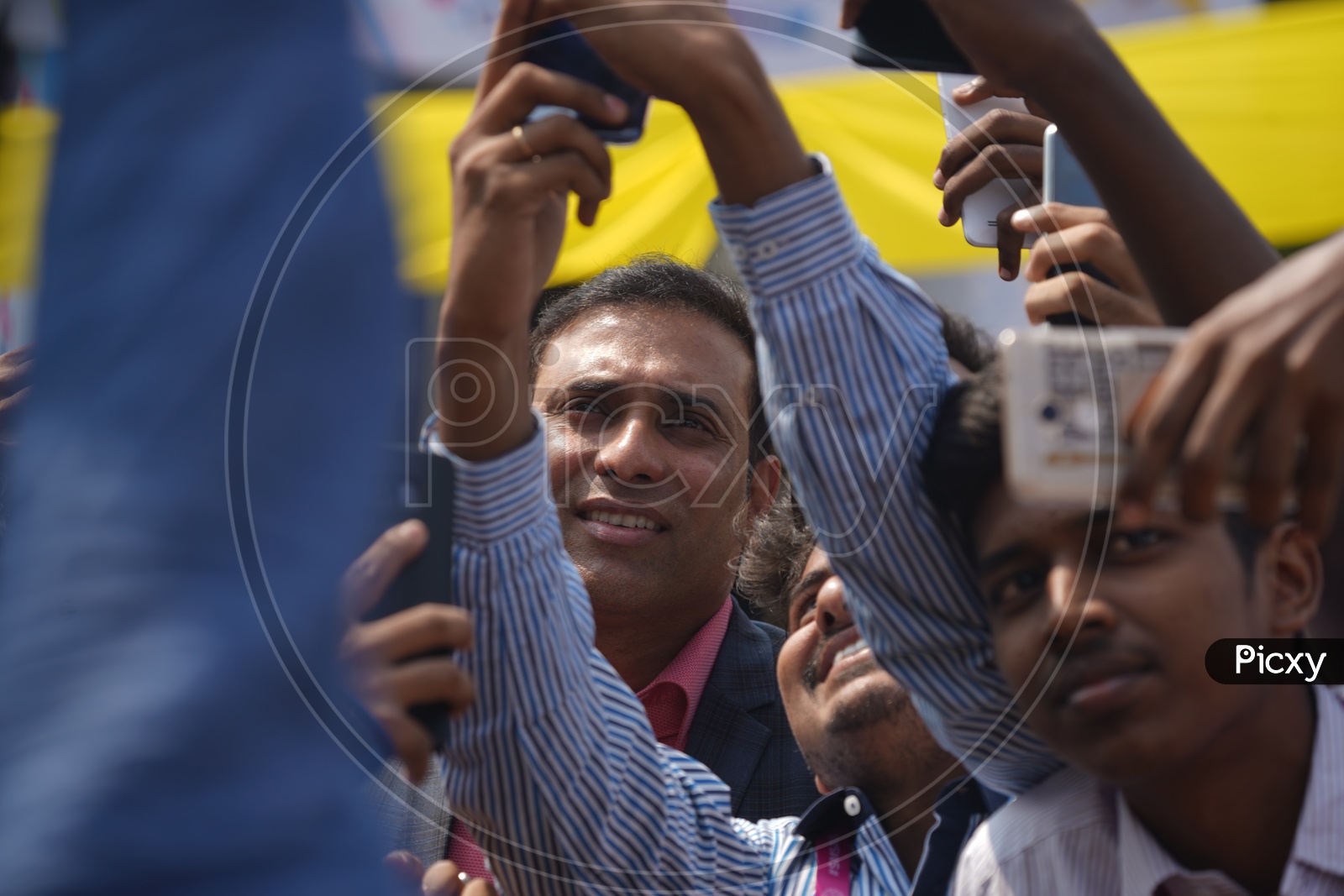 Students take selfies with former Indian cricketer V V S Laxman while he arrives to address the Social Media Summit in Amaravati 2018