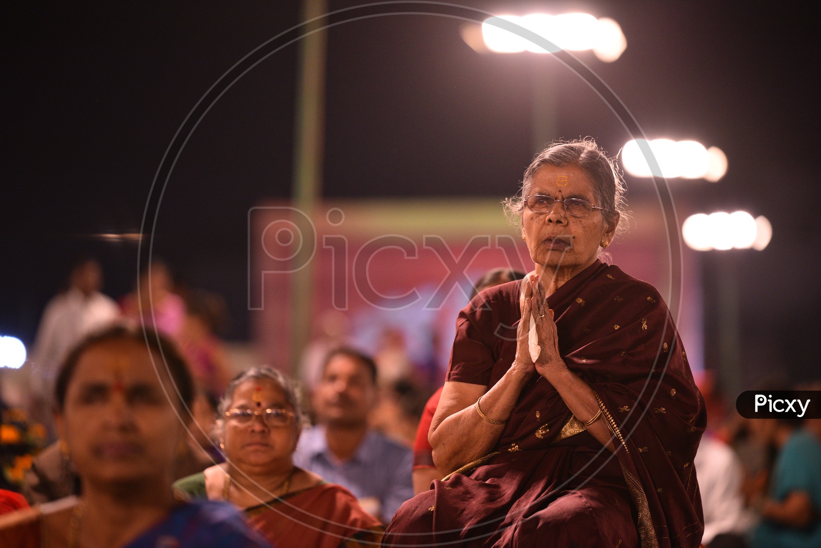 an elder woman devotee at Koti deepotsavam