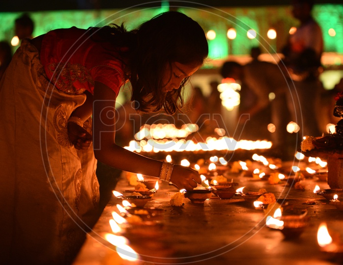 A girl lighting Diya , Deepam