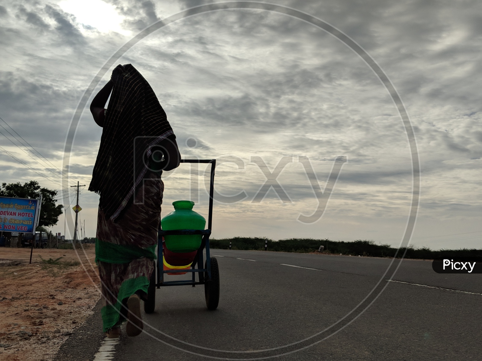 Village Woman walking with a trolley