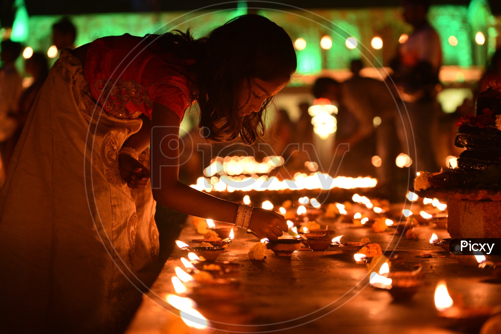 A girl lighting Diya , Deepam