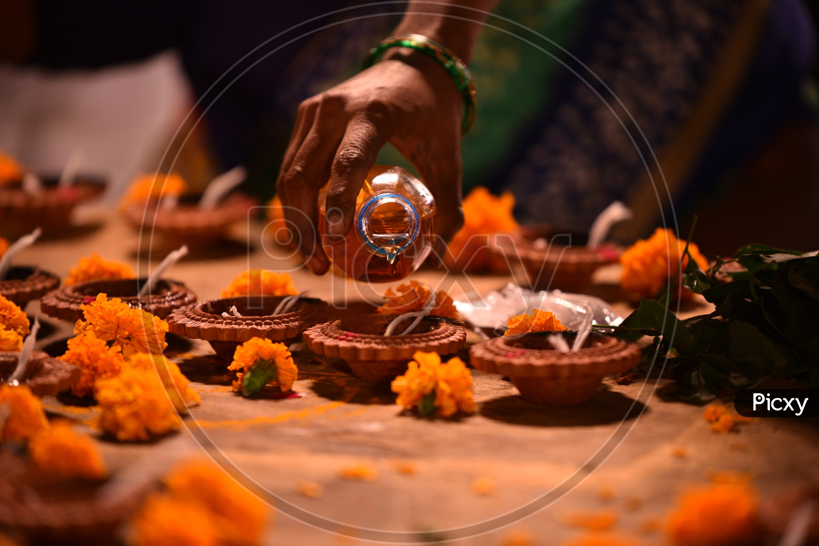 Diyas being filled with Pooja Oil