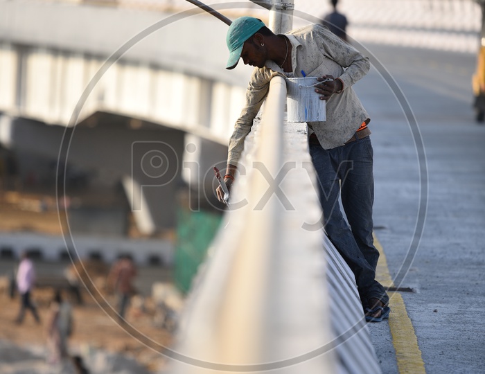a man seen painting the new flyover at Mindspace Junction