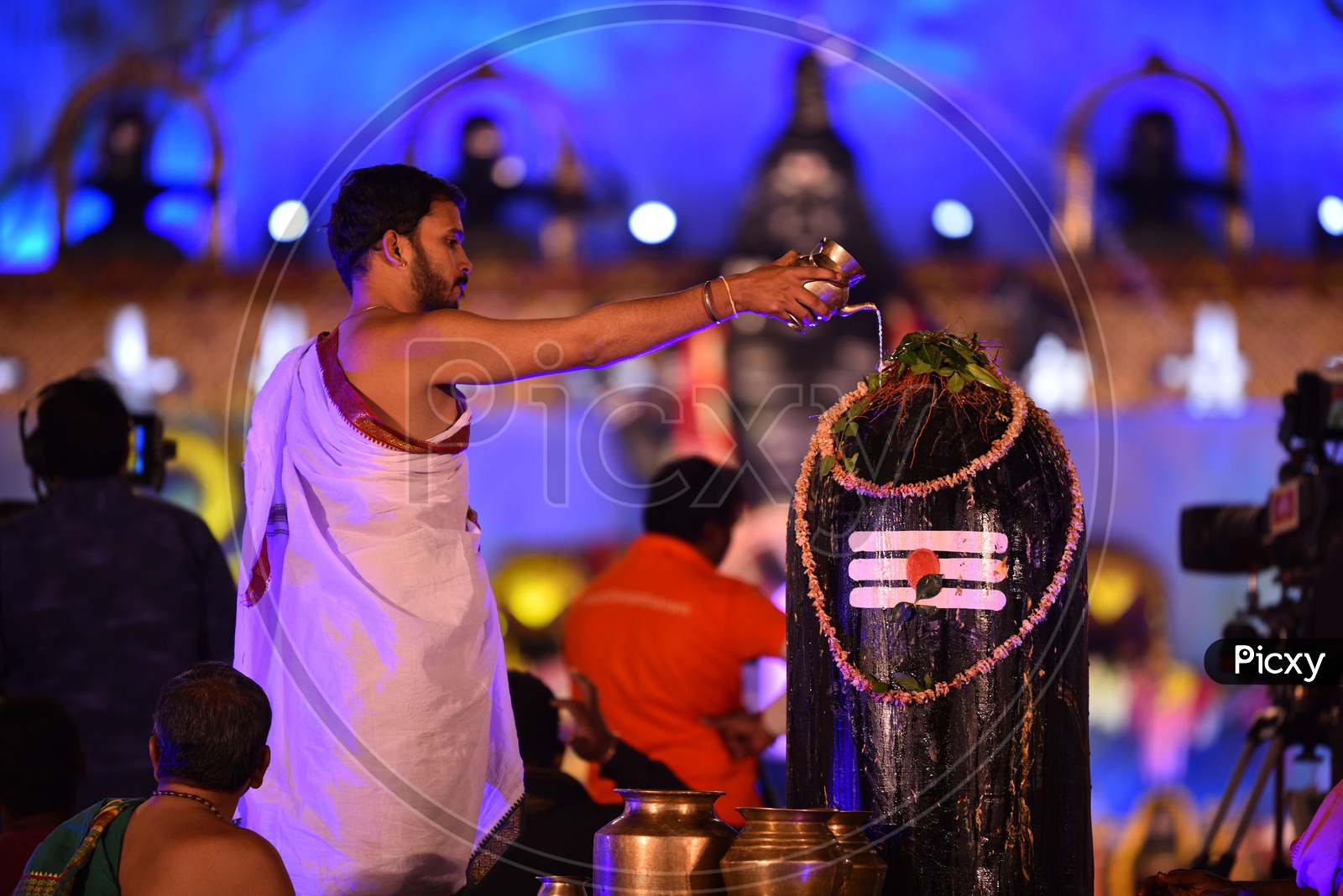 A Pujari performing rites to Shiva Linga