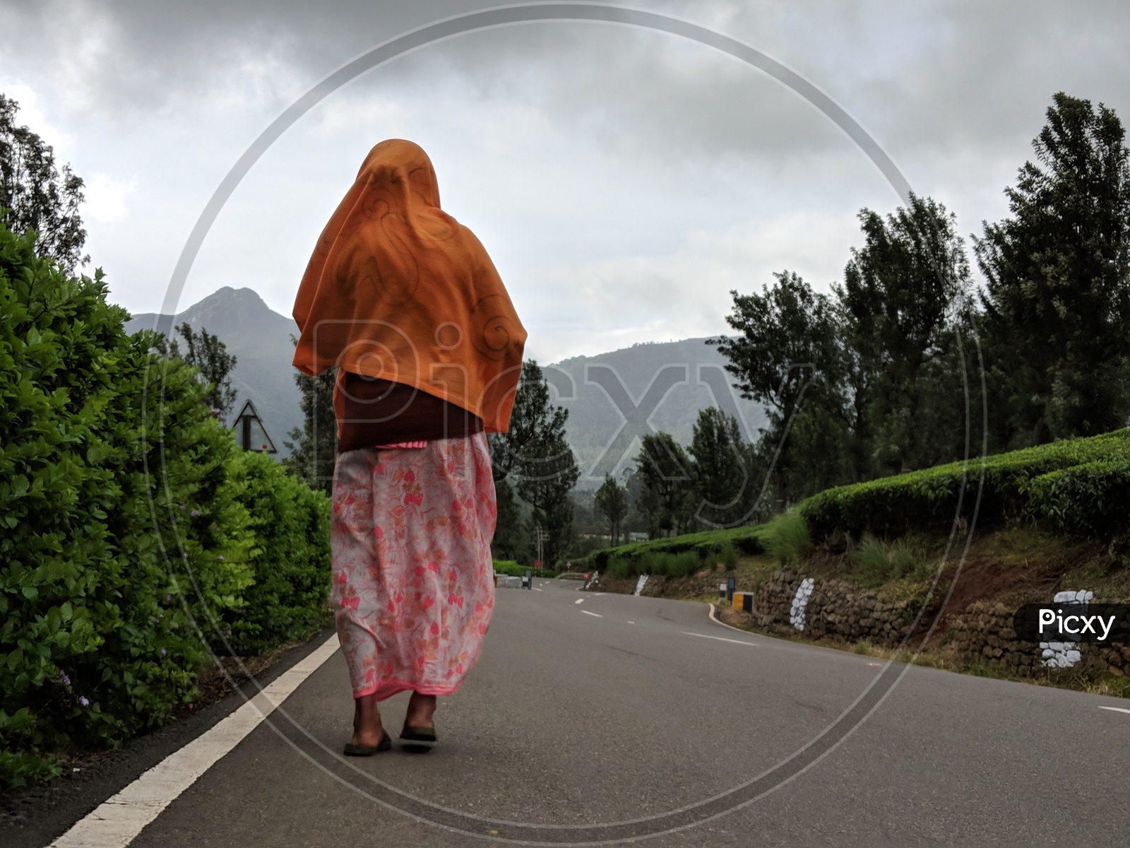 Woman walking on road near Valaparai Tea Plantations