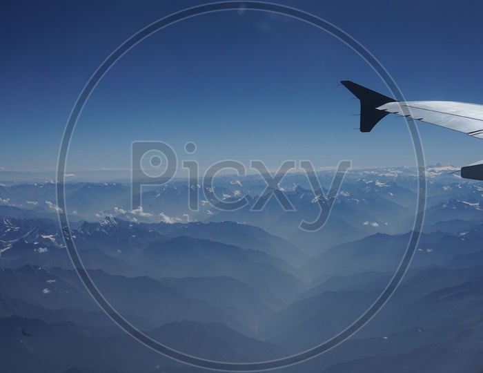 Himalayan mountains captured from aircraft /  Himalayas in Aerial View / Snow Capped Mountains