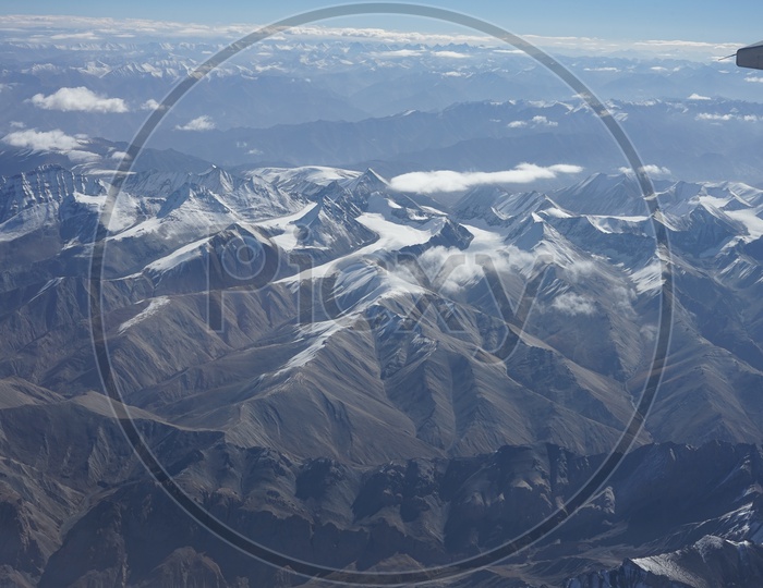 Beautiful Himalayan Snow capped mountains captured from aircraft/Himalayas Ranges in Aerial View