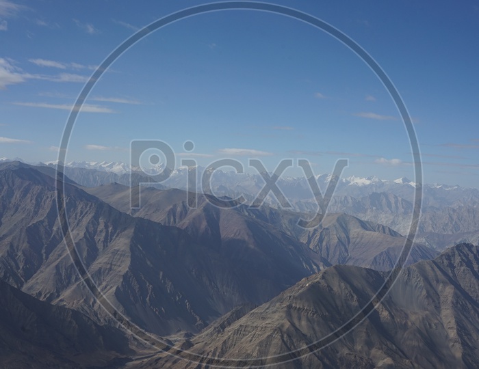 Beautiful Landscape of Himalayan mountains captured from aircraft /  Himalayas / Snow Capped Mountains / Himalayas with Beautiful Clouds
