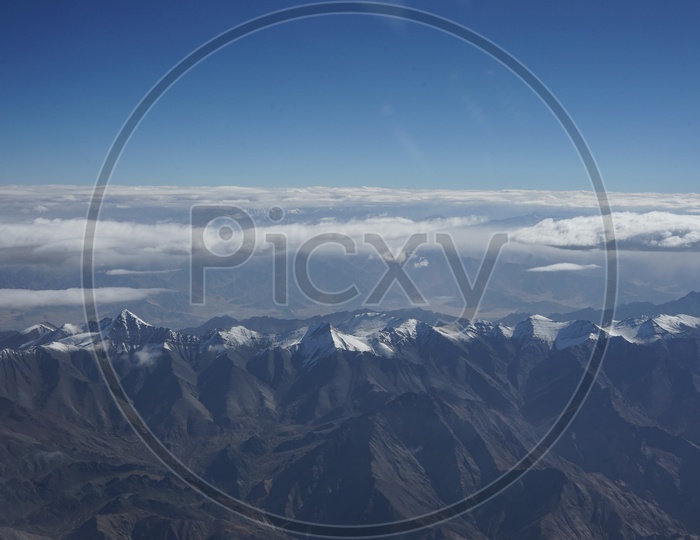 Beautiful landscape of Himalayas where clouds are over Snow Capped Mountains