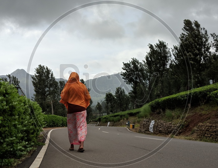 Woman Walking on road near Valaparai Tea Plantations