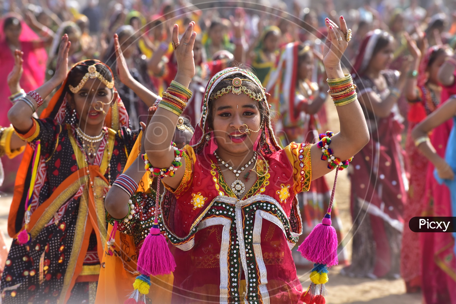 Women in Colorful dresses dancing at Pushkar Camel Fair
