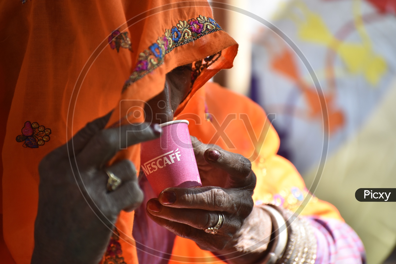 Rajasthani Woman in Traditional Attire Drinking Coffee at Pushkar Camel Fair