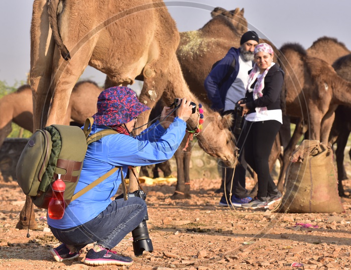 Foreign Tourist Taking Photo of Local Man at Pushkar Camel Fair