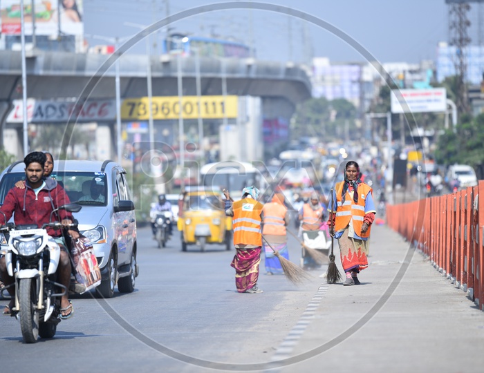 GHMC Workers Cleaning the Bharat Nagar Flyover on Morning Hours