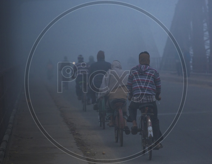 Foggy Mornings Of Varanasi  / Locals Commuting On Cycles As a part Of their Daily Life Routine in Varanasi India