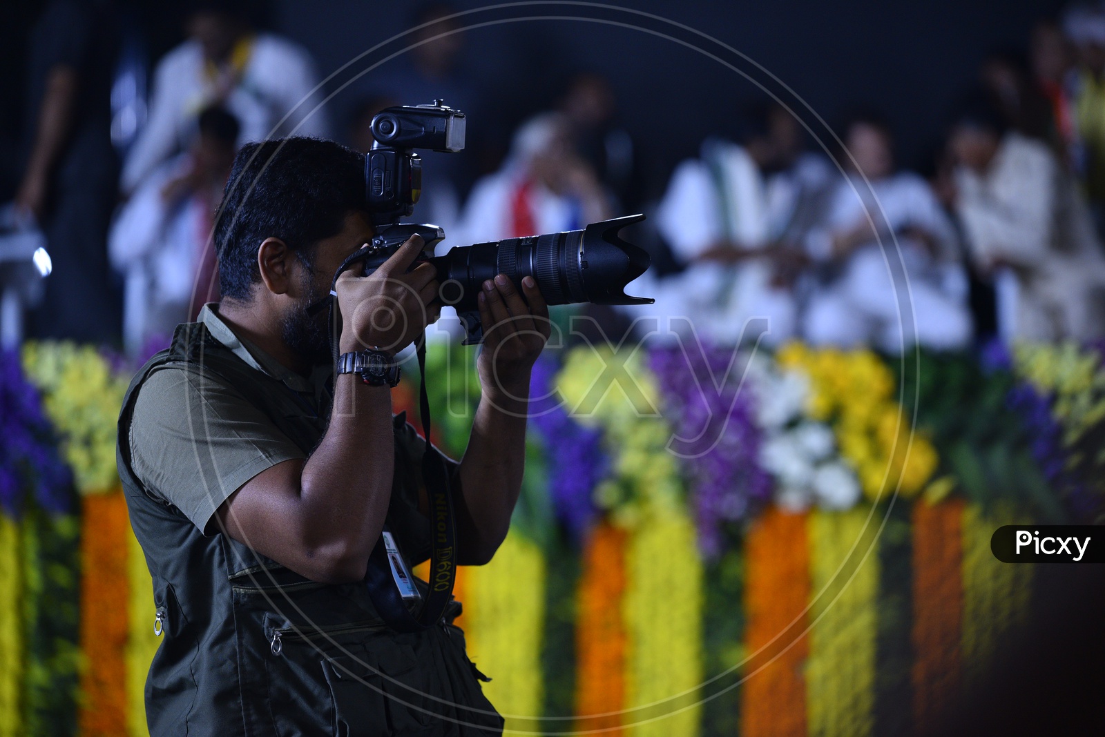 A photographer clicking photographs at  Mahakutami meeting in Ameerpet