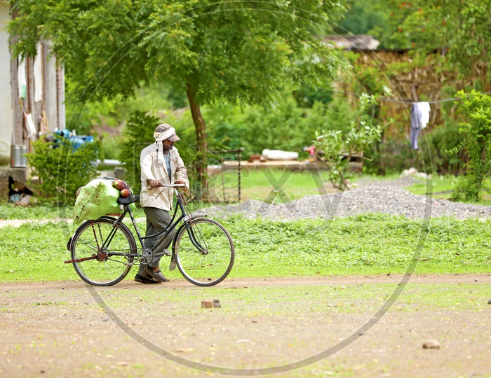 Rural Indian Villages. Farmer taking good on cycle.