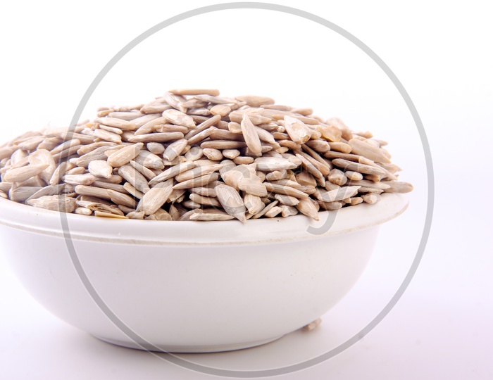 Pumkin Seeds In a Bowl on an Isolated white Background