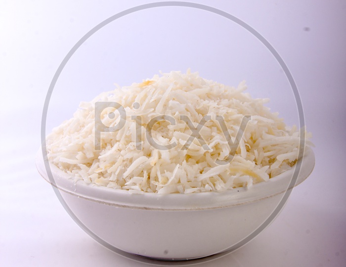 Dried Grated Coconut in a Bowl on an Isolated White Background