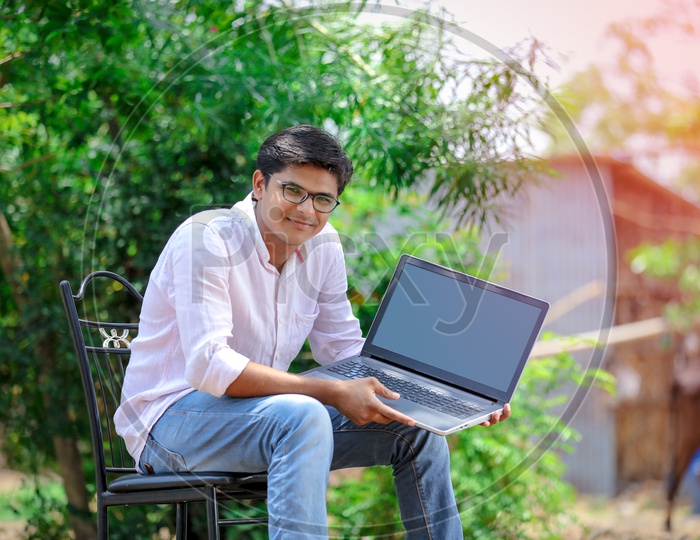 Indian College Student using Laptop with smiling face