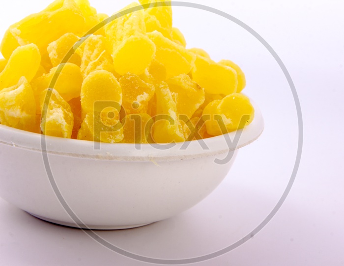 Dry Mango Pieces in a Bowl On an Isolated White Background