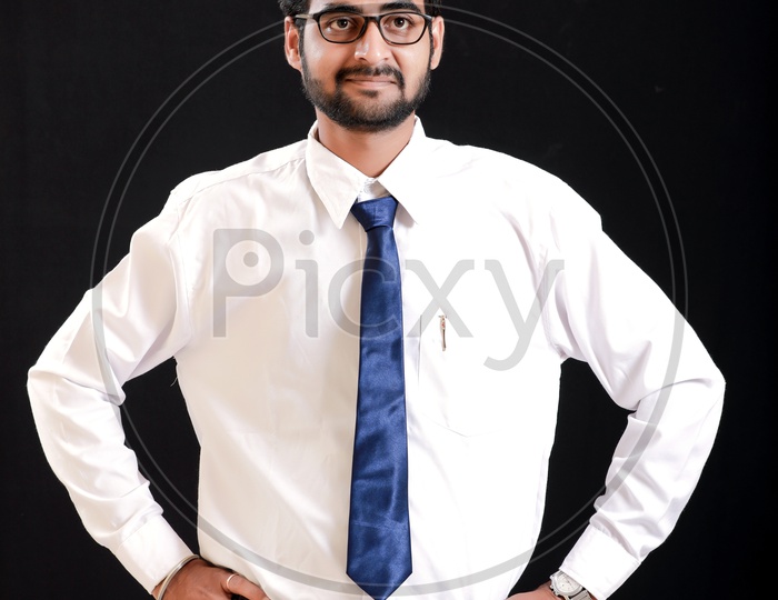 Portrait Of A Confident Young man in Formal wear Showing into Space and  looking to Camera With Black Background