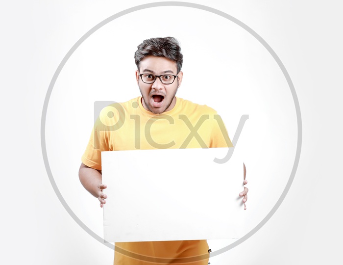 Young Indian Model Showing Blank Poster and white background.