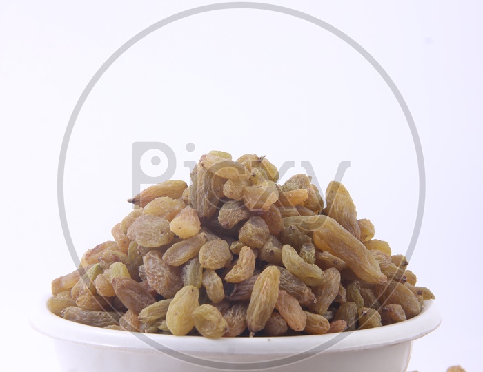 Bowl of Raisins / raisins in a Bowl isolated on a White Background