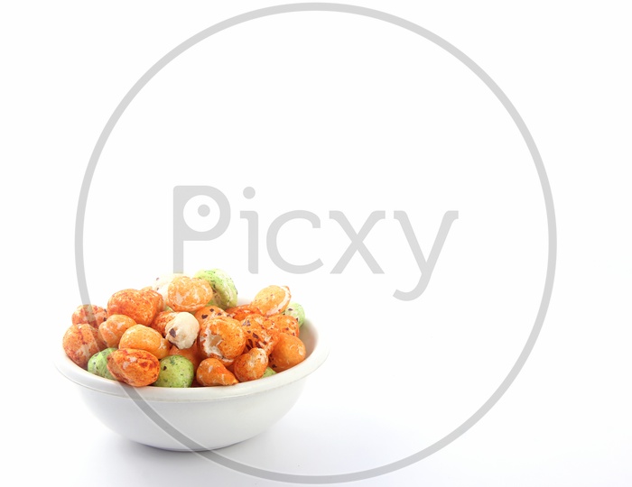 Coloured Fox Nuts / Gorgon Nuts /Makhana / Lotus Seed Pops in a Bowl on an Isolated White Background