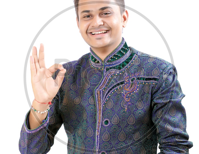 Indian Man In a Traditional Wear with  Expression and Hand Signs gestures  holding a Gift Box in Hand on an Isolated White Background