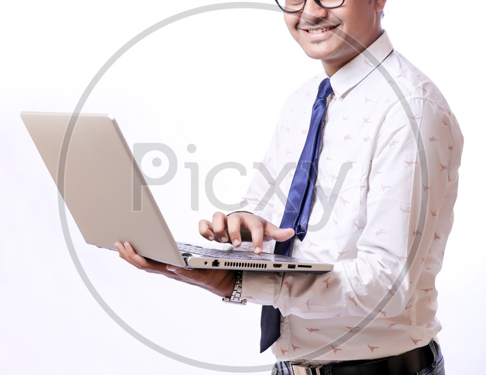 Portrait Of A Confident Youngman in Formalwear  With Expression and Laptop Open In His Hands  With White  Background