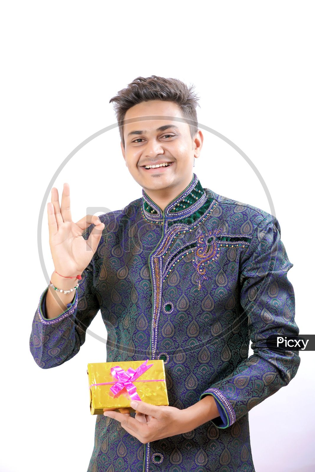 Indian Man In a Traditional Wear with  Expression and Hand Signs gestures  holding a Gift Box in Hand on an Isolated White Background