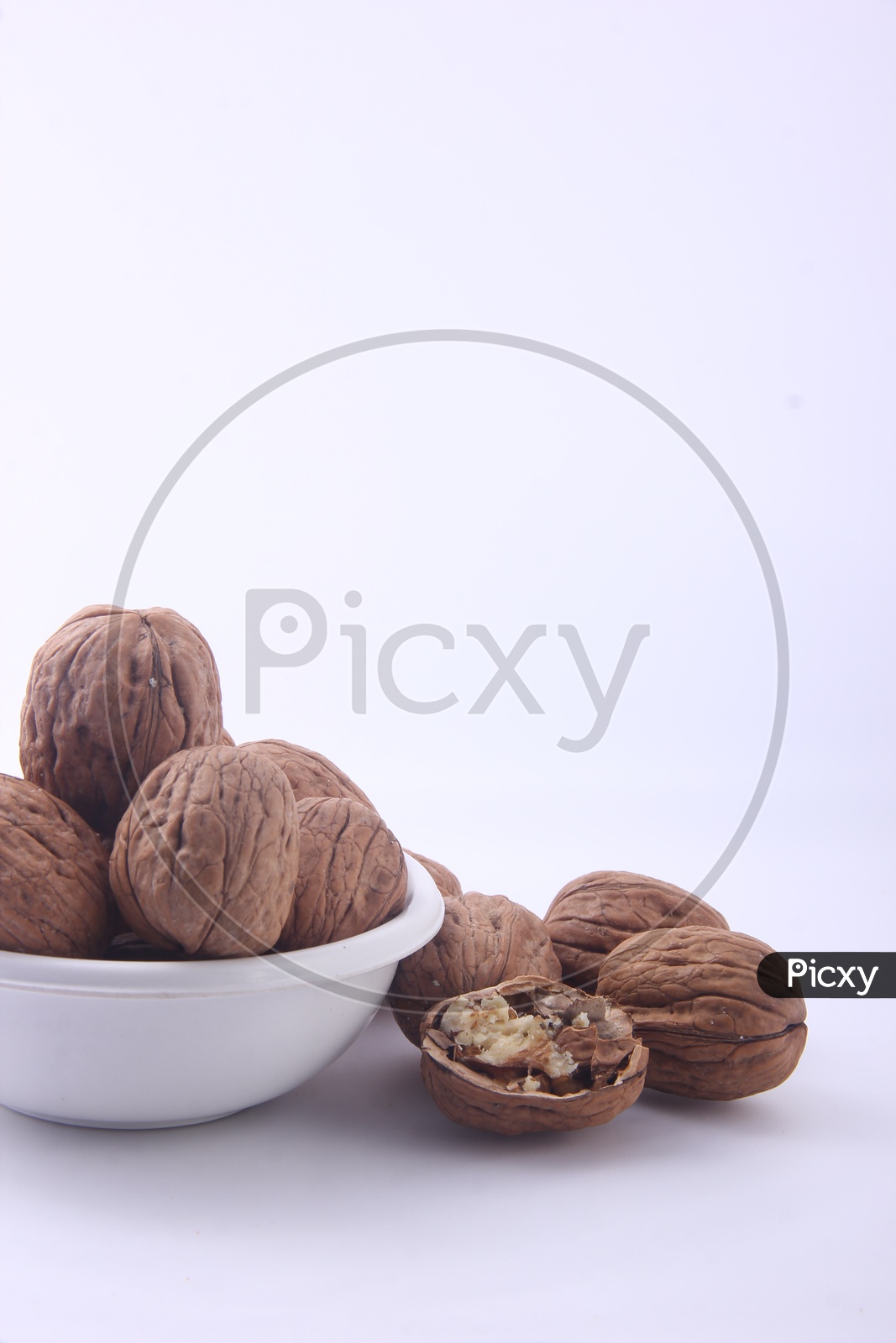 Wallnuts in Bowl  Composition Shot on a Isolated White Background