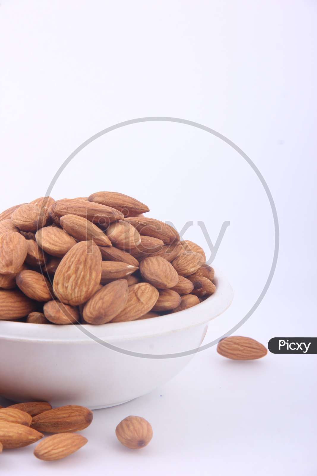 Almonds in Bowl on an Isolated white Background