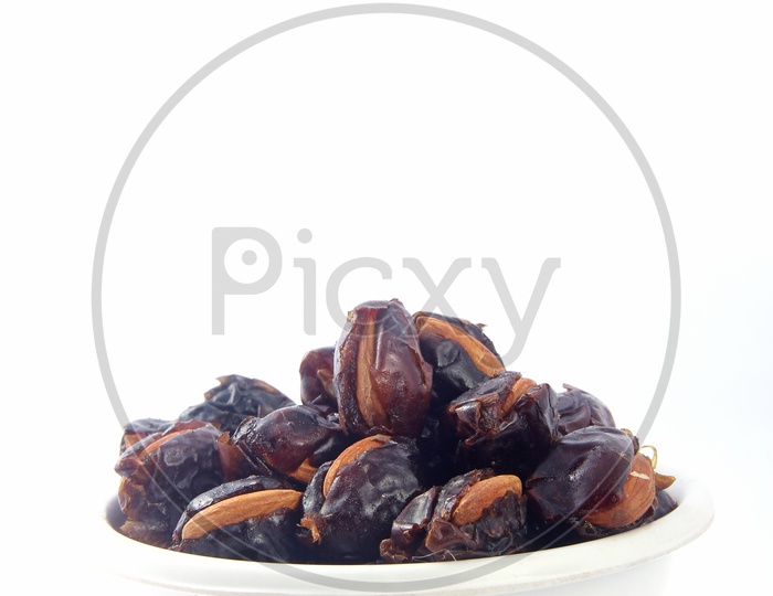 Almond-Stuffed Dates in Bowl Isolated in White Background