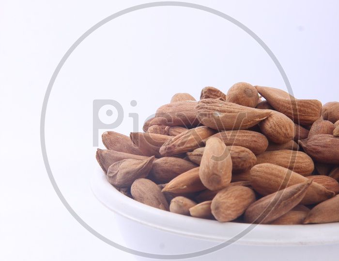 Almonds in Bowl on An Isolated White Background