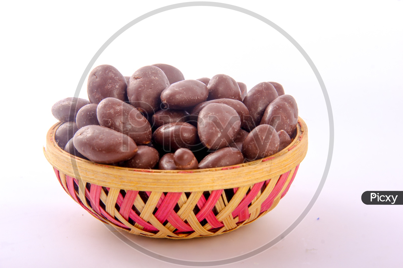 Chocolate Coated Almonds in Bowl Isolated in White Background